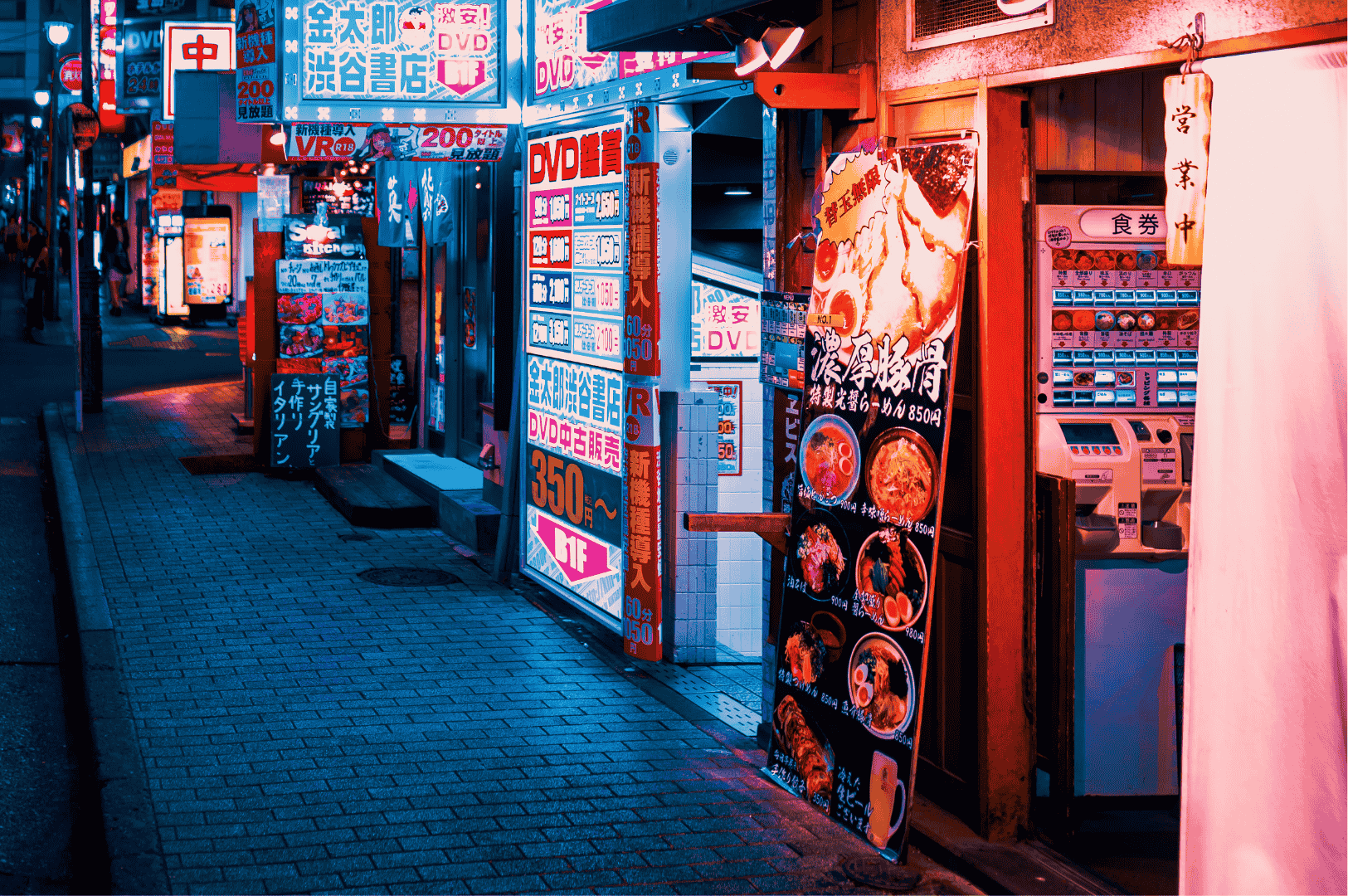 Tokyo-Late-Night-Ramen- (2) Neon-lit Tokyo alley glowing with red, blue, and pink signage, vending machines, and ramen shop menus—capturing the electric pulse of late-night noodle haunts tucked between storefronts and secrets.