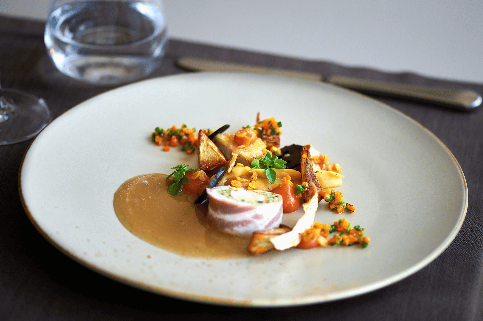 Best-Resto-SG- (3) A meticulously plated roulade garnished with root vegetables and vibrant sauces—an artful expression of Singapore’s fine dining excellence.