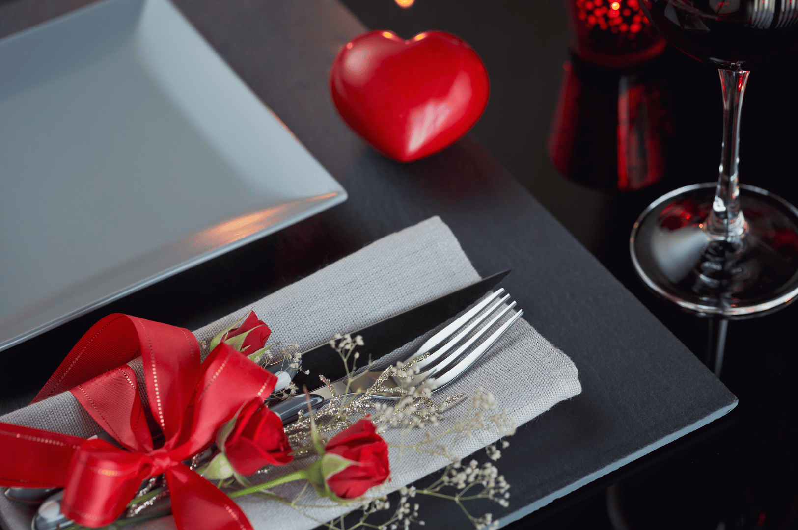 Best-Resto-SG- (5) A romantic table set with roses, candlelight, and wine—perfect for celebrating love in Singapore’s finest restaurants.