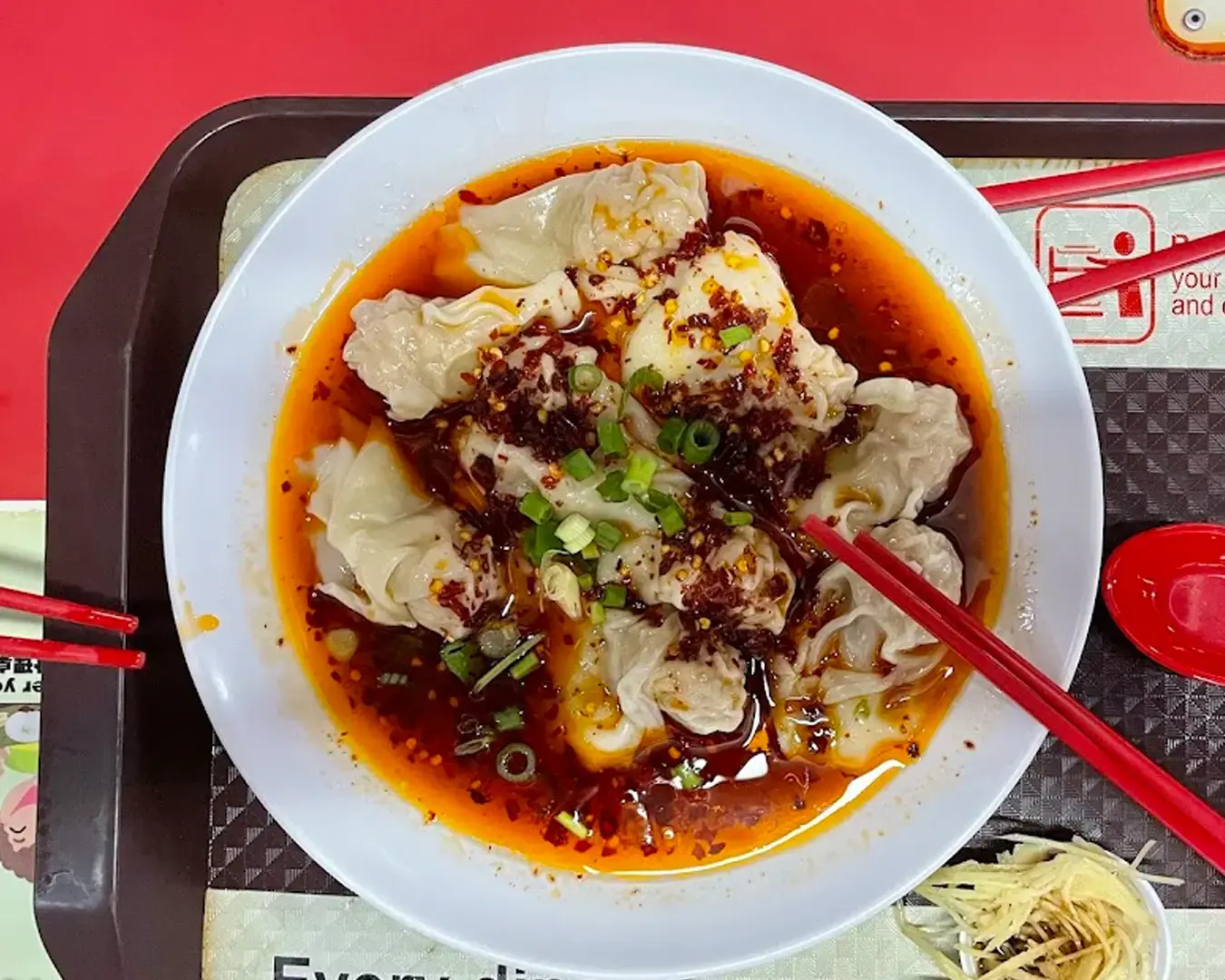 A close-up of delicate soup dumplings release hot savoury broth with every bite.