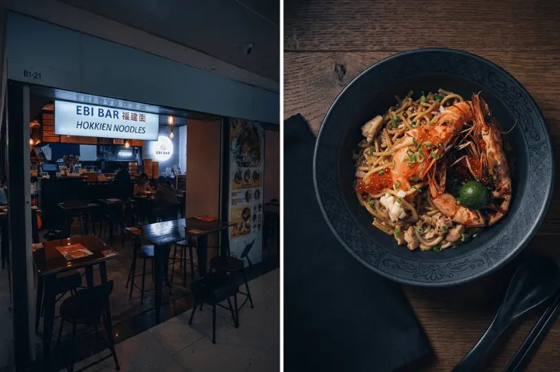 Side-by-side composite; the left shows the warmly lit storefront of Ebi Bar Hokkien Noodles against the dark mall corridor, and the right features a top-down shot of Hokkien noodles topped with large prawns and roe in a black bowl, demonstrating how to manage highlights on a dark wooden table.