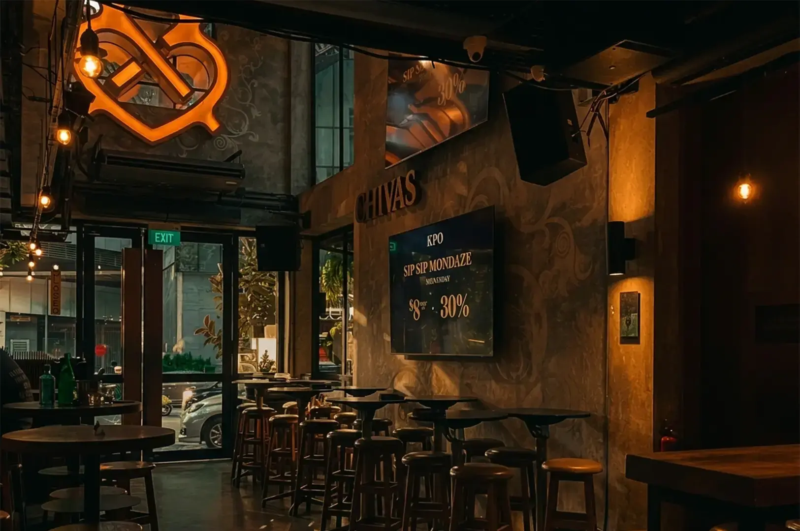 Interior of KPO Café Bar on Killiney Road, with warm lighting, dining tables and the bar area visible inside the former post office building.