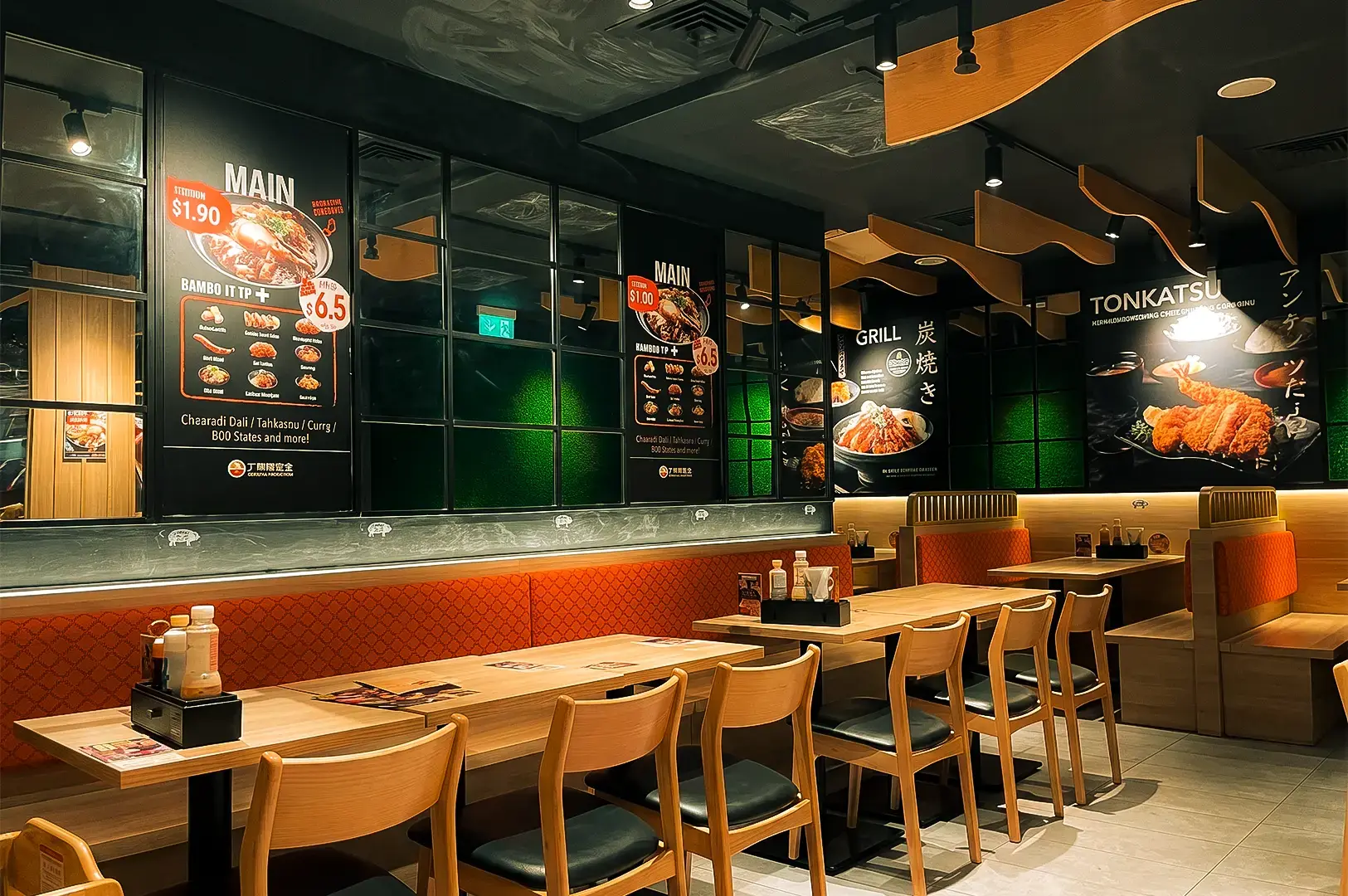 Gochi-So Shokudo interior with cozy empth chairs and tables surrounded by food and menu posters with wood accents in the ceiling.